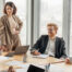 Business professionals in a meeting discussing legal and compliance matters in a modern office.